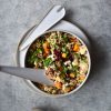 A bowl of vegetarian quinoa salad on a light backdrop