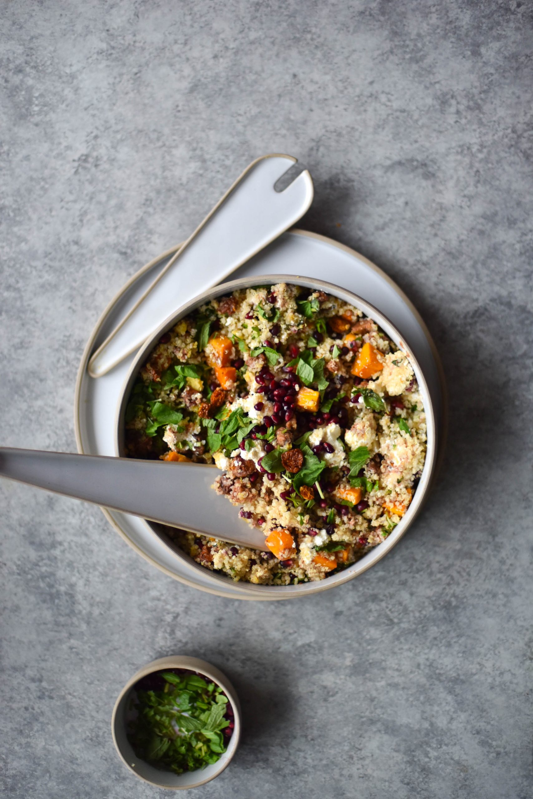 A bowl of vegetarian quinoa salad on a light backdrop