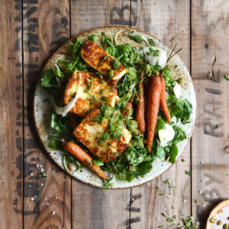 Honey and butter roasted carrot salad with halloumi and green herb sauce from www.georgeats.com