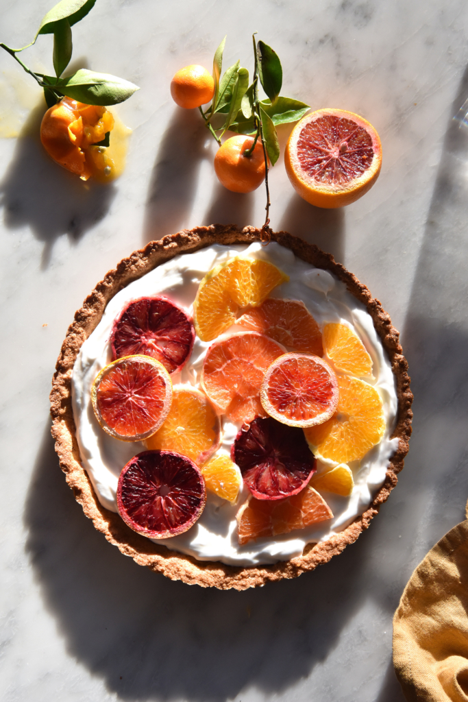 Coconut yoghurt tart with gluten free quinoa flake crust and citrus topping from www.georgeats.com
