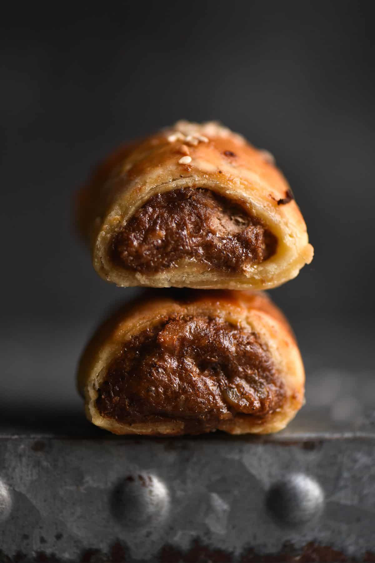 Two FODMAP friendly, gluten free and vegetarian sausage rolls stacked on top of eachother