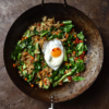 An aerial image of a dark rusty wok filled with low FODMAP fried rice atop a dark rusty backdrop
