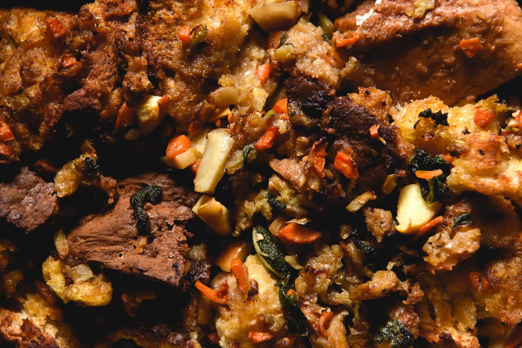 An aerial macro image of gluten free vegan stuffing that is golden brown in colour