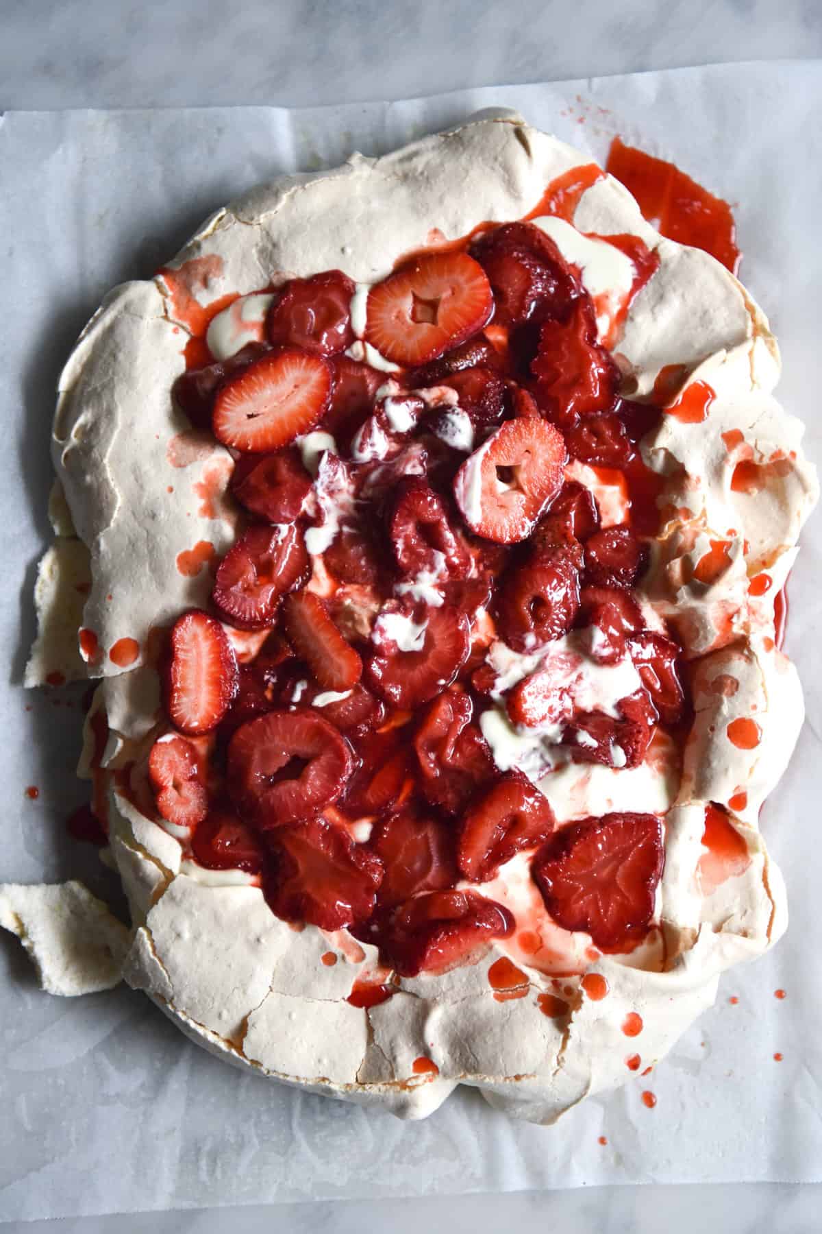 Orange blossom and lemon myrup roasted strawberries on a kaffir lime pavlova from www.georgeats.com