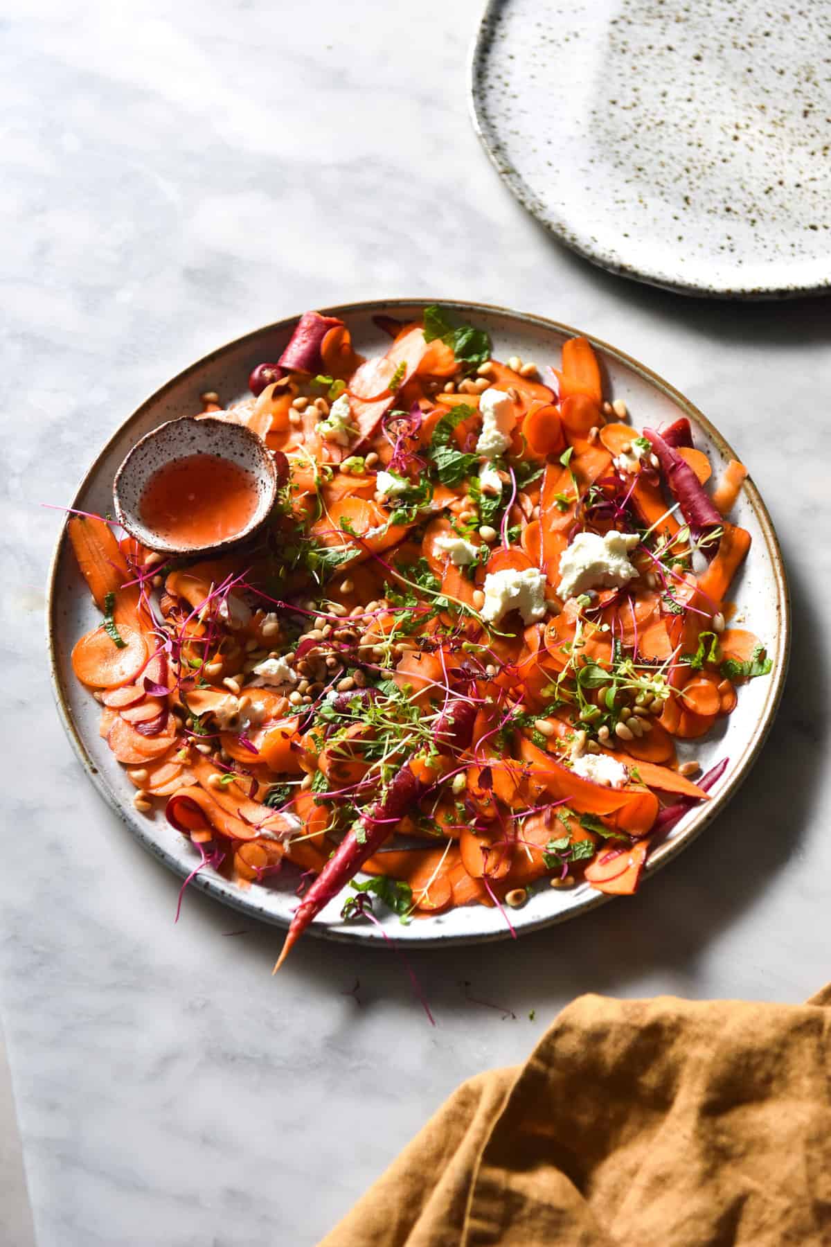 Shaved carrot salad with goat's cheese, toasted pine nuts, mint and an orange blossom, lemon and Campari dressing from www.georgeats.com. Gluten free, FODMAP friendly and vegetarian.