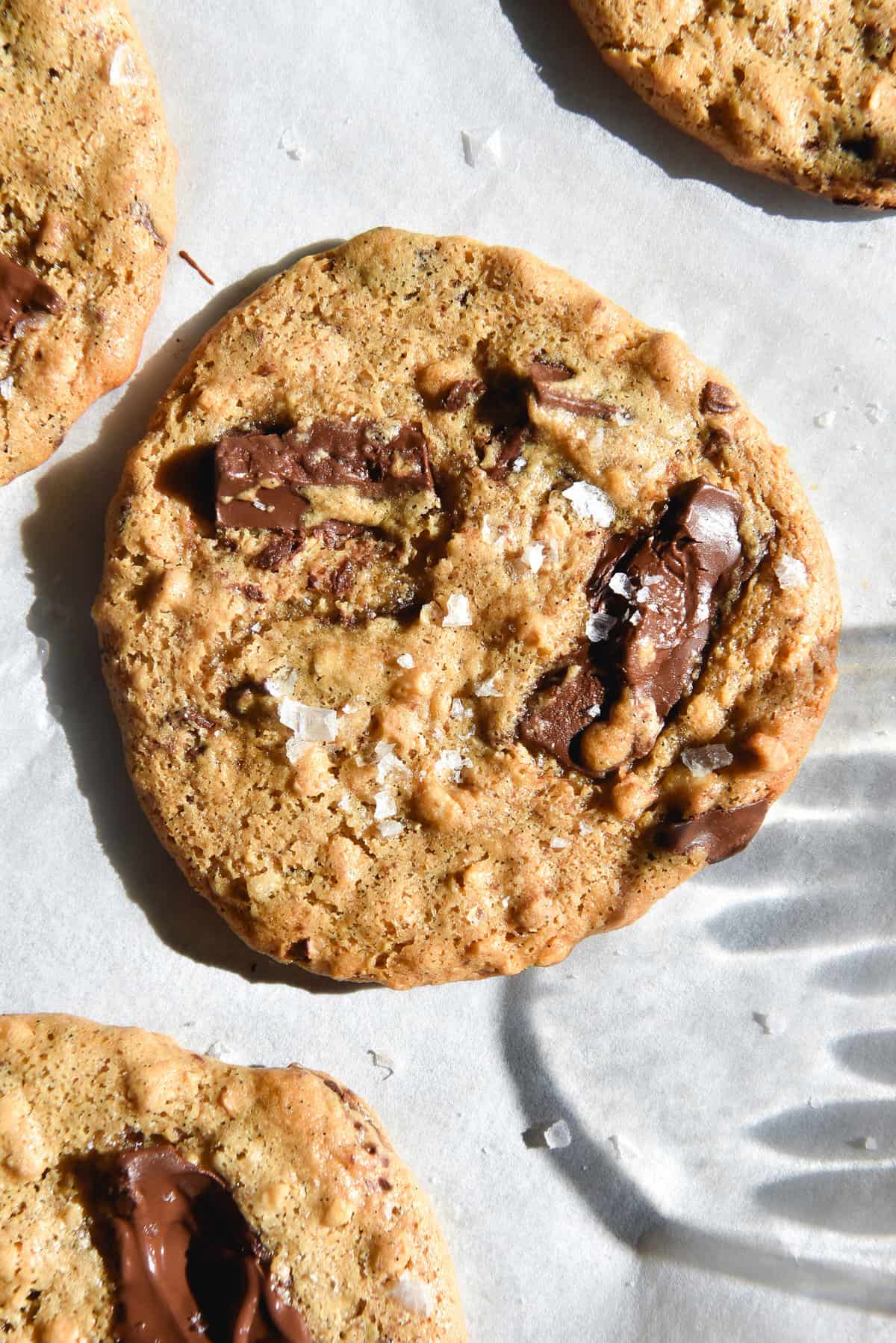 An aerial image of gluten free peanut butter cookies on a baking sheet in bright sunlight. 