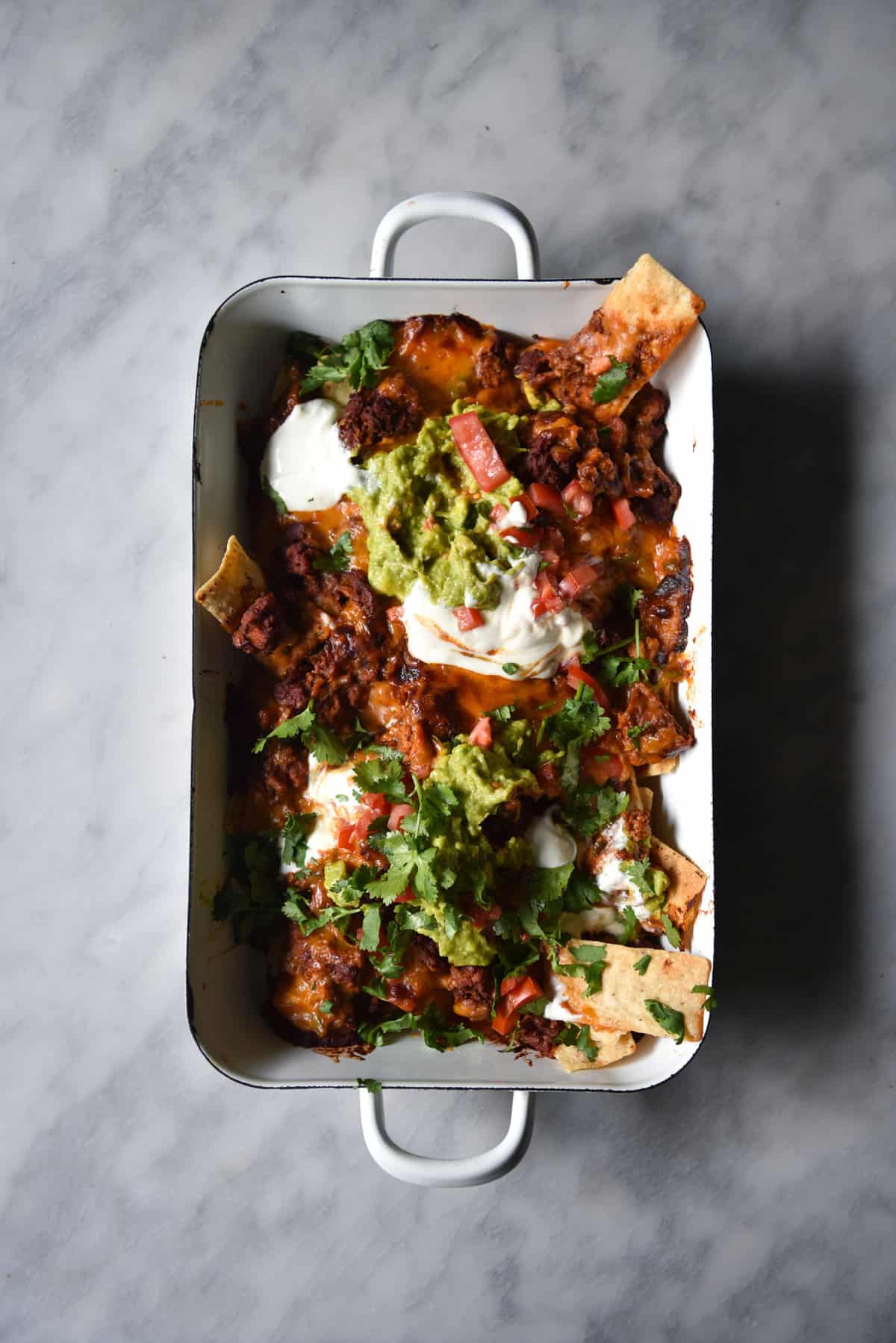 FODMAP friendly vegetarian nachos with chilli, queso and guacamole from www.georgeats.com