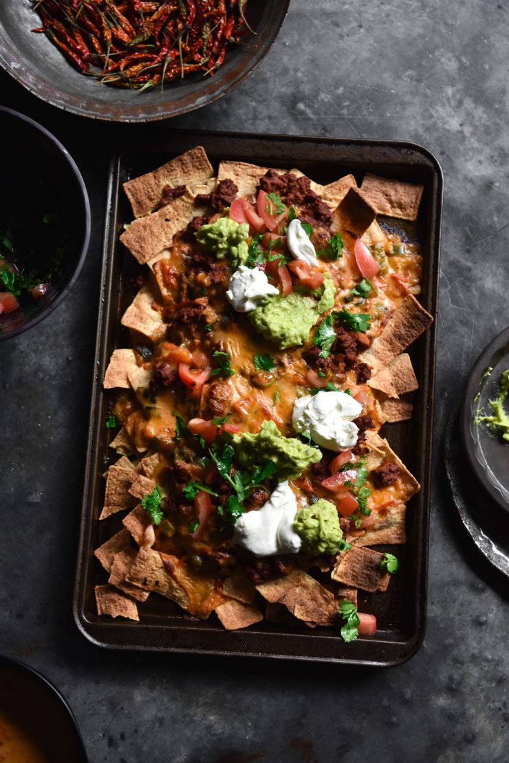 Vegetarian nachos with 'mince' queso, guacamole and salsa. Gluten free and FODMAP friendly, from www.georgeats.com