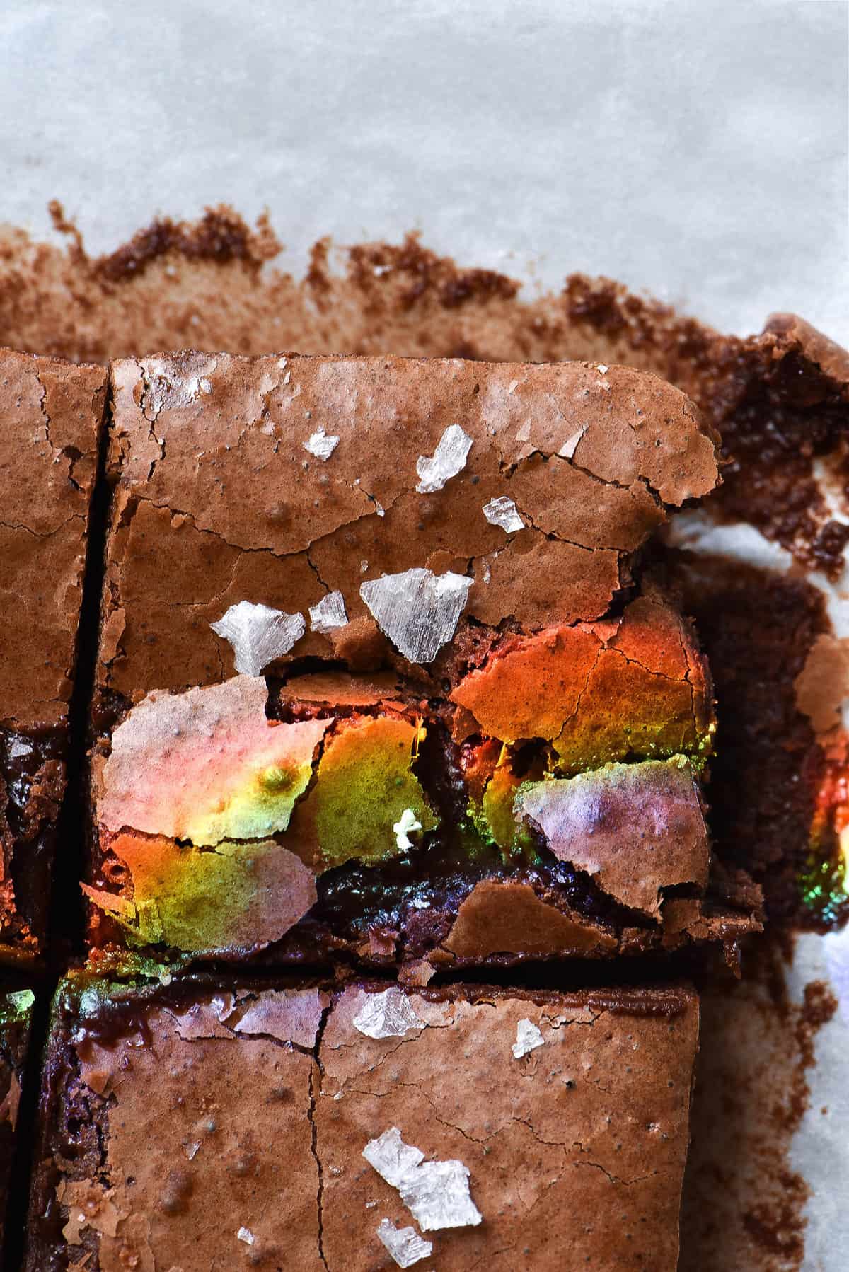 Gluten and grain free fudgy brownies with a crackly top, sea salt flakes and a sunshine created rainbow on top