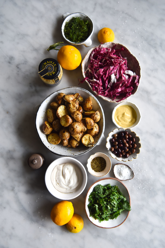 Vegan potato salad with a zingy mayo dressing, radicchio, olives, pine nuts and fresh herbs. FODMAP friendly, gluten free and easy to make. www.georgeats.com @georgeats