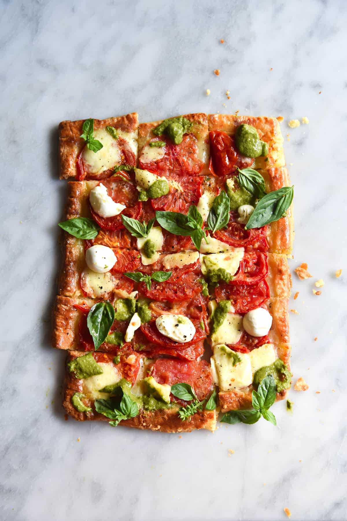 Gluten free tomato tart with gruyere and pesto. Gluten free, vegetarian, FODMAP friendly and easily adapted to be nut free. 