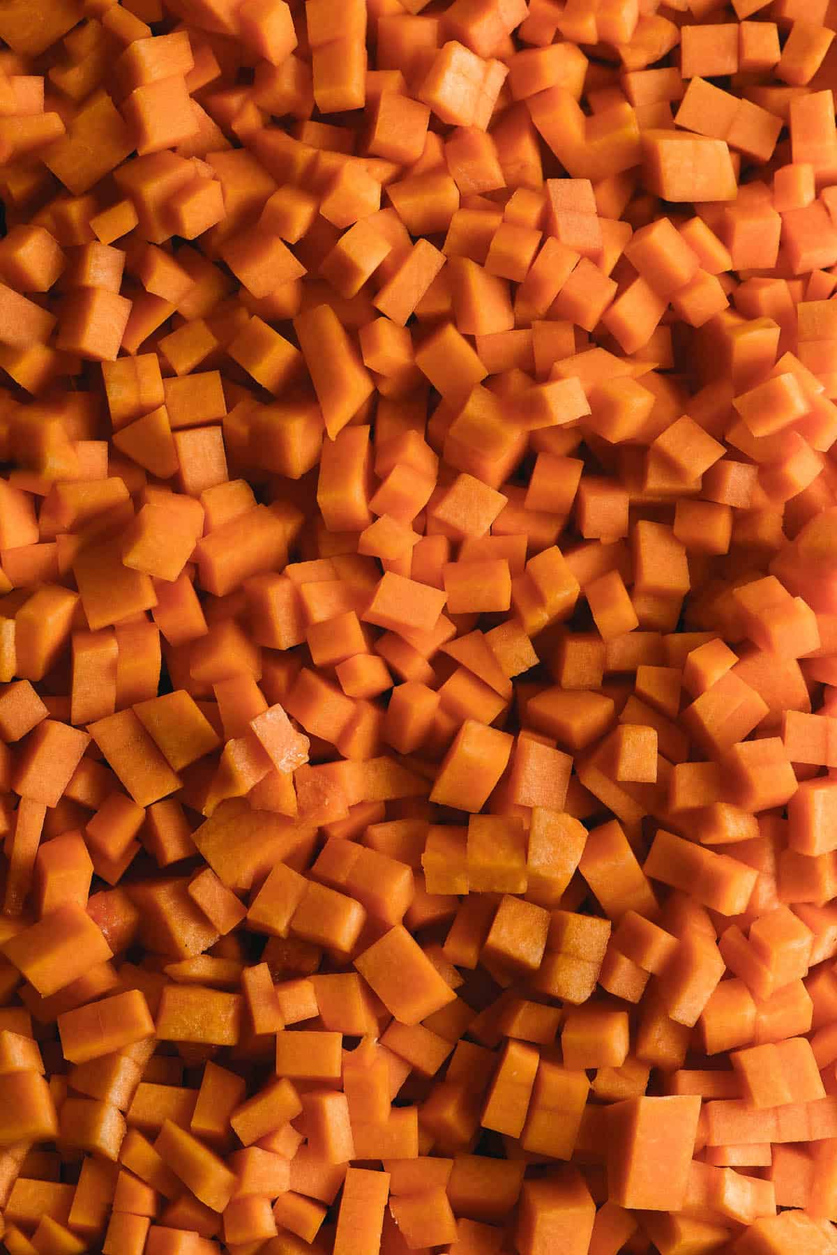 A close up image of small 1/2 - 1 centimetre pumpkin cubes 