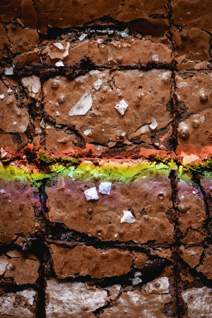 Gluten free nut free brownies with a crackly top, sea salt flakes and a sunshine created rainbow on top.
