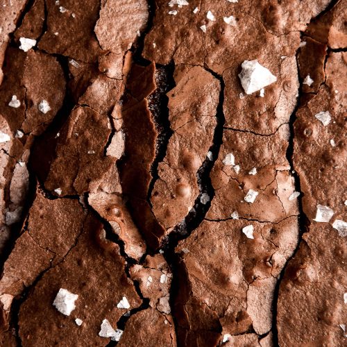 A close up aerial macro image of a gluten free nut free brownie with a crackly top.