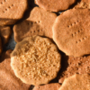 An aerial sunlit close up view of a plate of gluten free graham crackers topped with finishing sugar