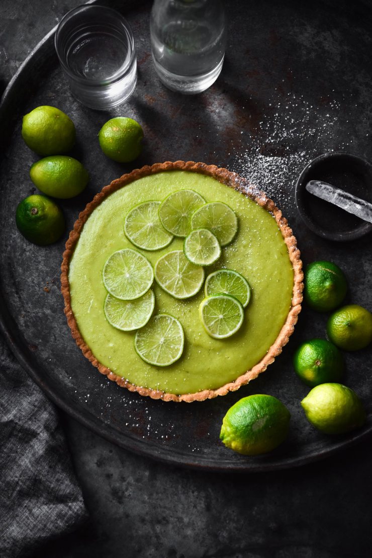 Gluten free FODMAP friendly lime curd tart with a graham cracker crust. Recipe from www.georgeats.com