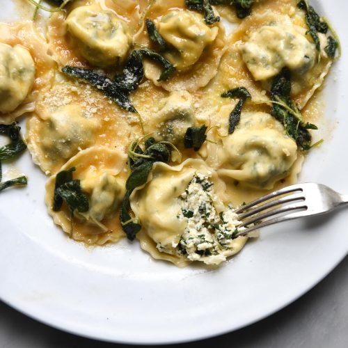 Homemade gluten free ravioli with lactose free ricotta and spinach filling and a brown butter crispy sage topping. FODMAP friendly, nut free, gluten free and vegetarian. Recipe from www.georgeats.com