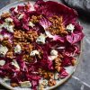 Radicchio salad with blue cheese and honey cinnamon walnuts, styled against a blue backdrop