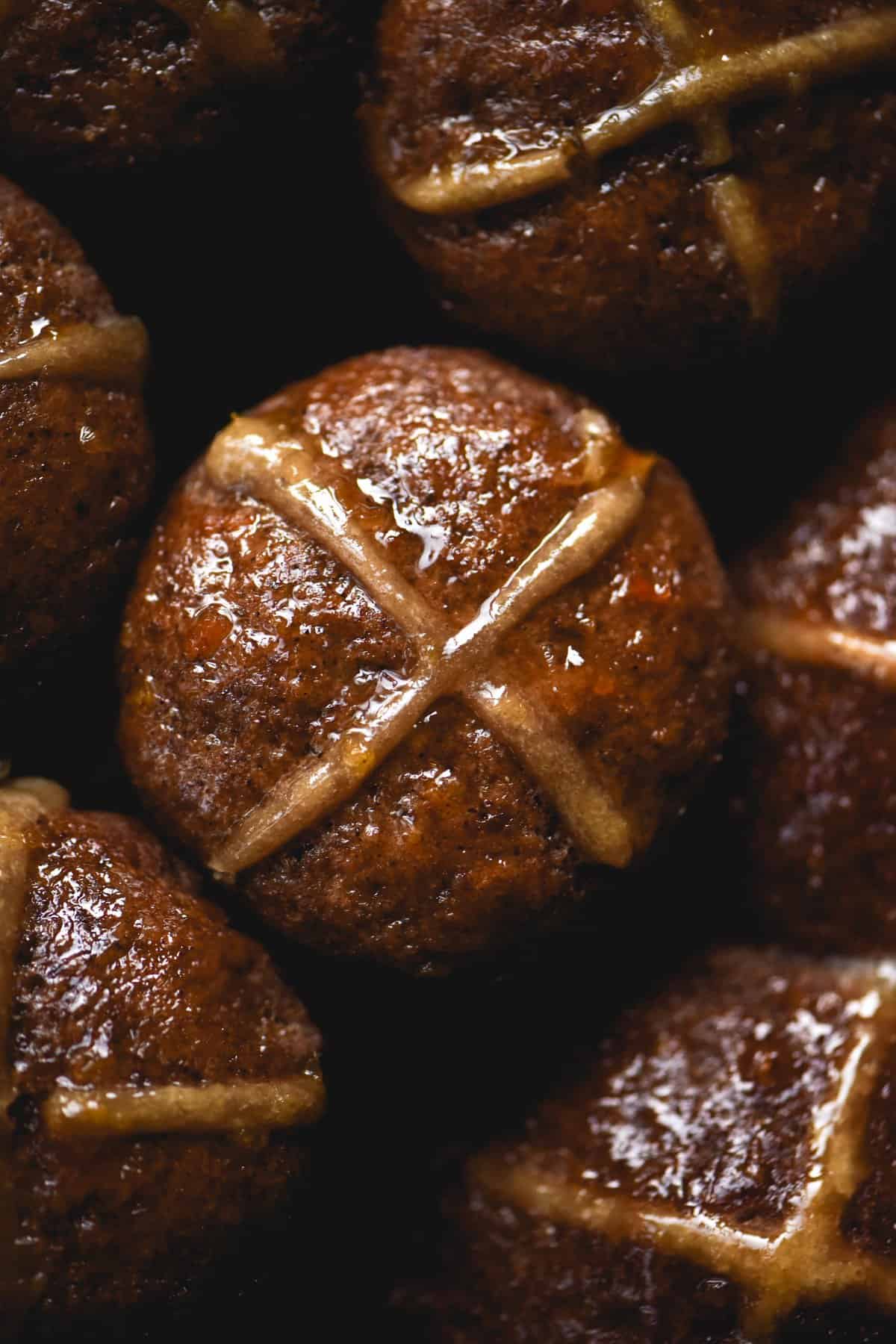 A close up macro shot of gluten free, vegan and FODMAP friendly hot cross buns