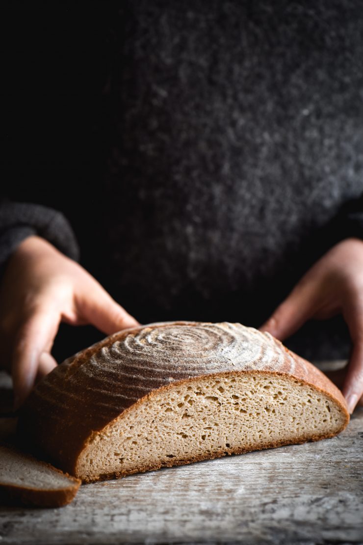 Hands Mixing Bread Dough In A Glass Mixing Bowl Stock Photo