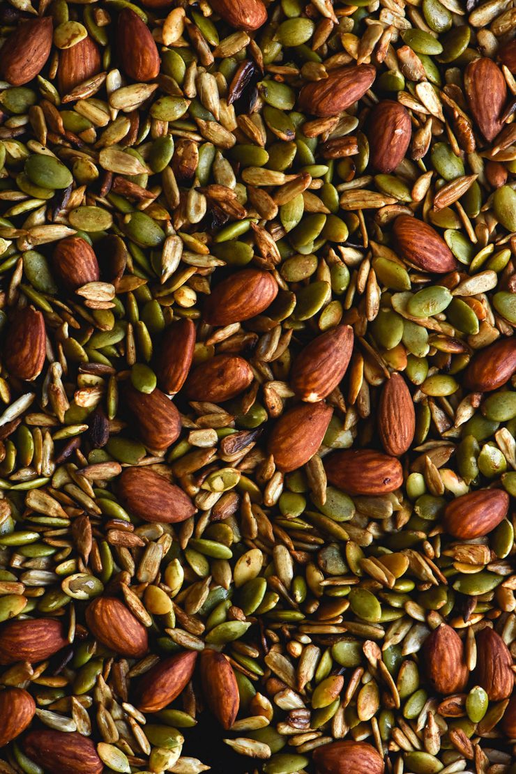 A close up macro image of a gluten free nut mix with pepitas, sunflower seeds and almonds cooked in Tamari