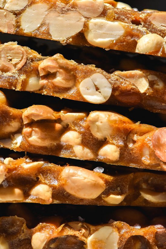 A close up macro image of a stack of low FODMAP peanut brittle