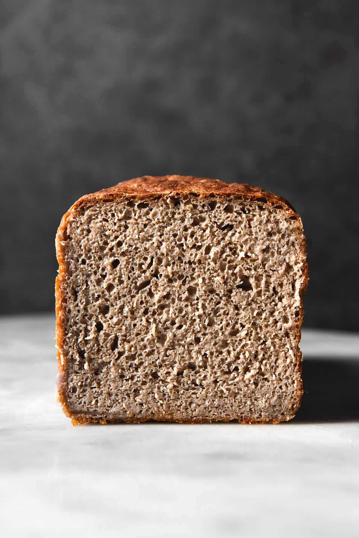 A side on image of the crumb of a gluten free, yeast free buckwheat bread recipe.