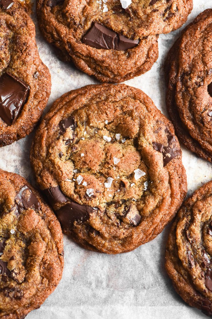 An aerial image of grain free choc chip cookies on a baking sheet lined with baking paper.