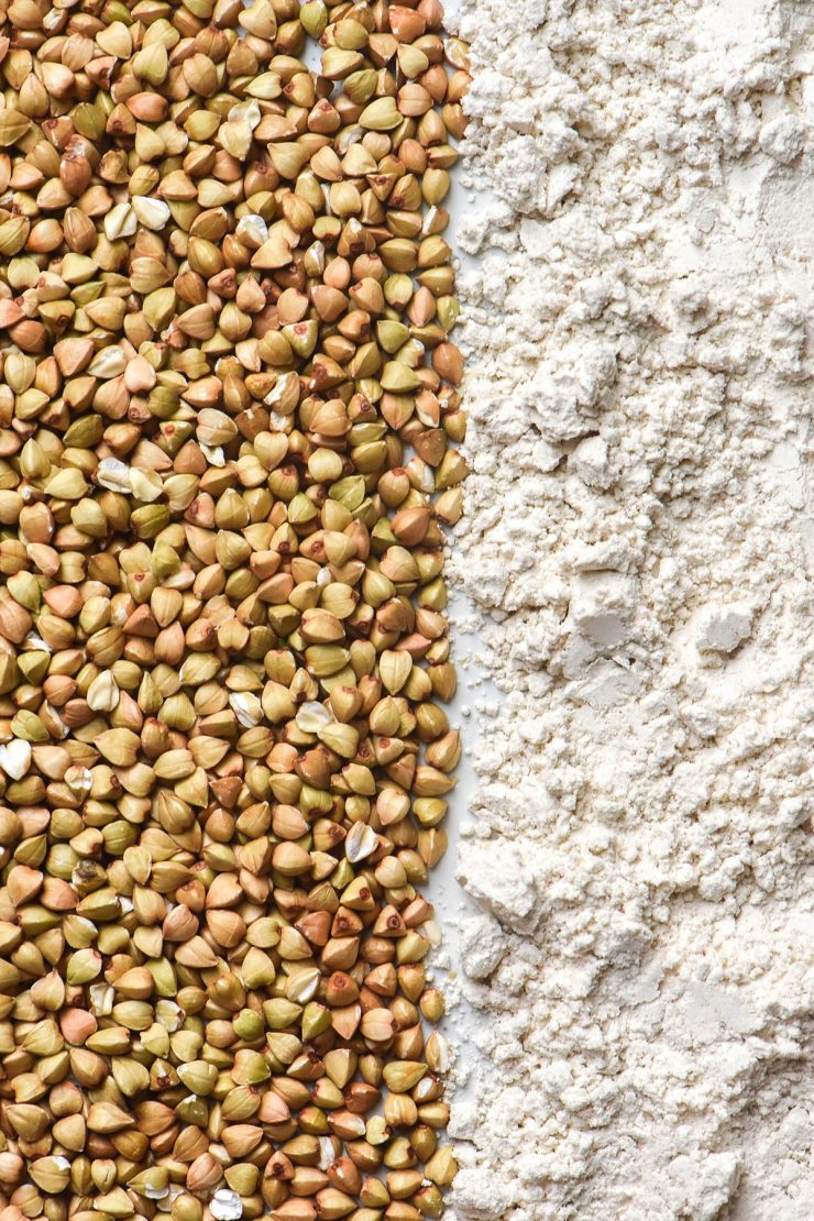 An aerial macro image of buckwheat groats and buckwheat flour arranged in horizontal lines