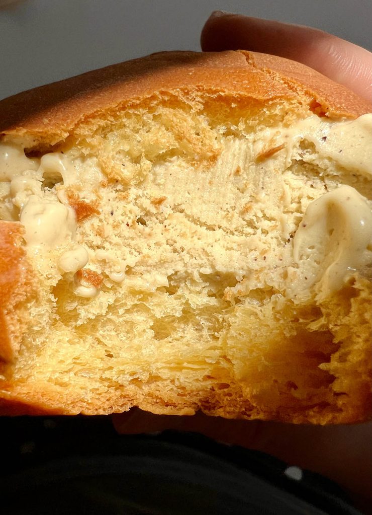 A close up image of a gluten free brioche filled with pistachio gelato from Caffè Adamo in Modica, Sicily