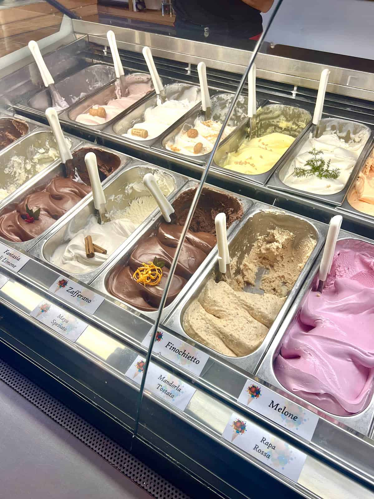 A selection of gelato flavours in the display fridge at Gelato DiVini in Ragusa, Sicily