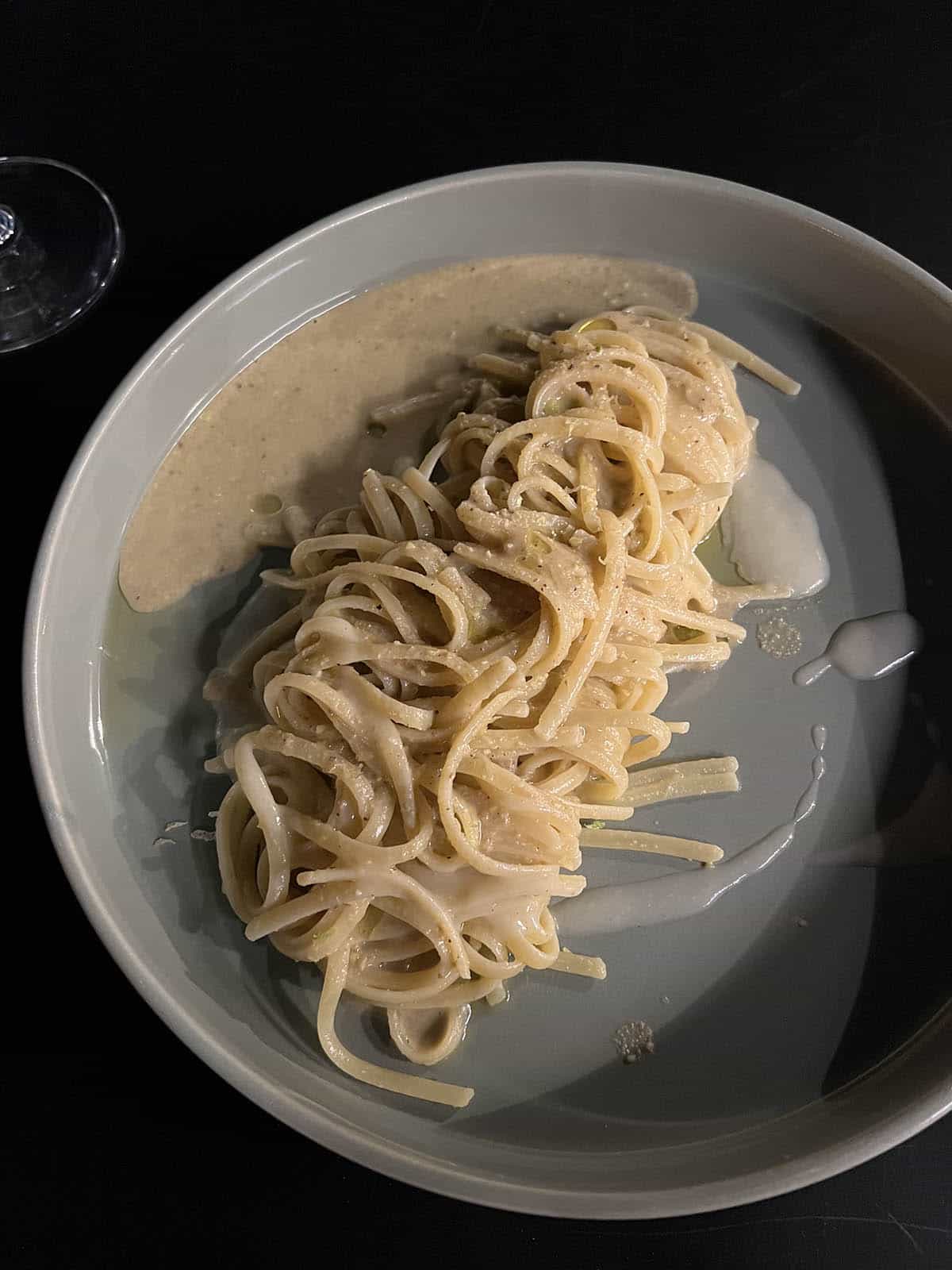 A night time image of a plate of bottarga and lime pasta from Scale Del Gusto, Ragusa, Sicily