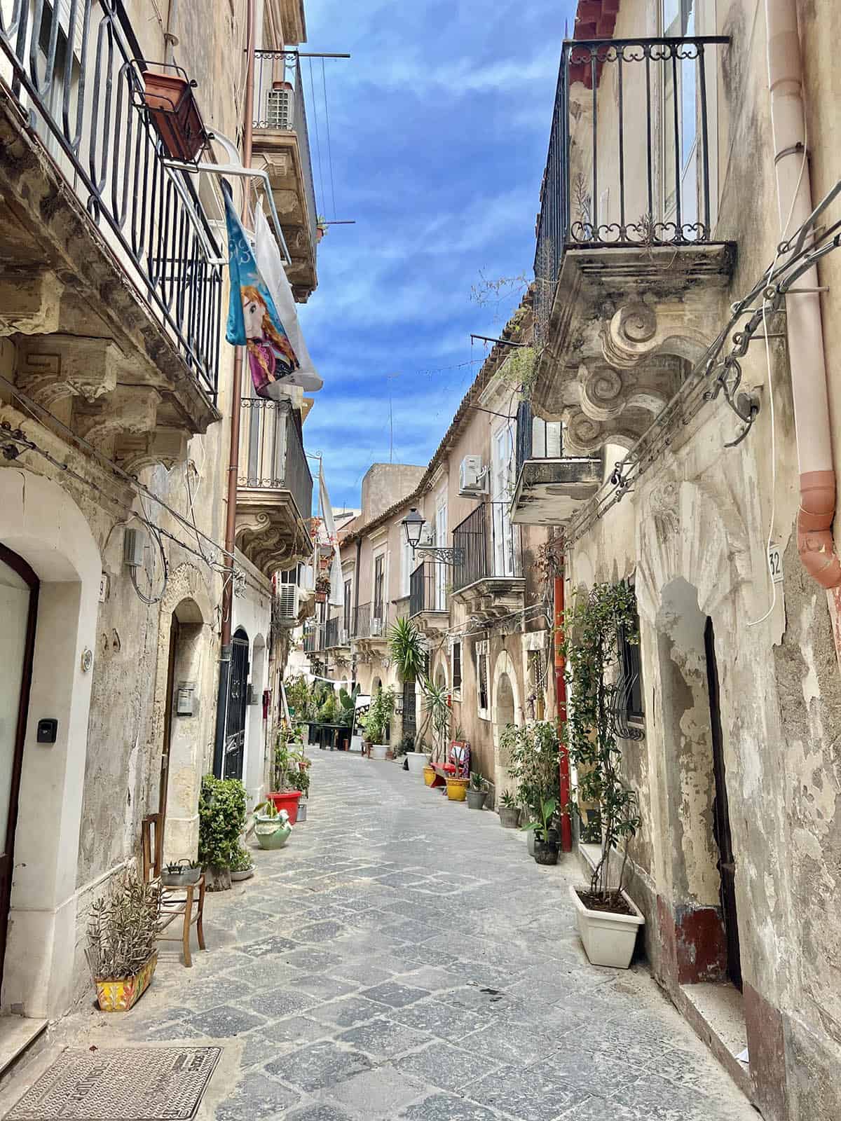 A view of the streetscape with blue skies in Ortigia, Sicily