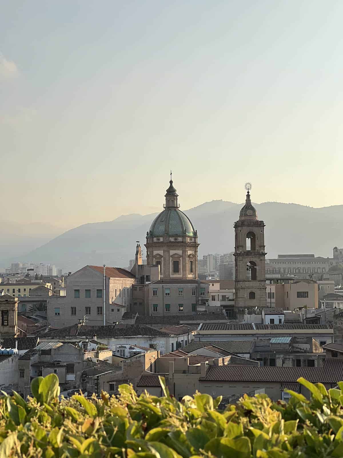 An image of Palermo skyline at dusk as viewed from a rooftop bar. 