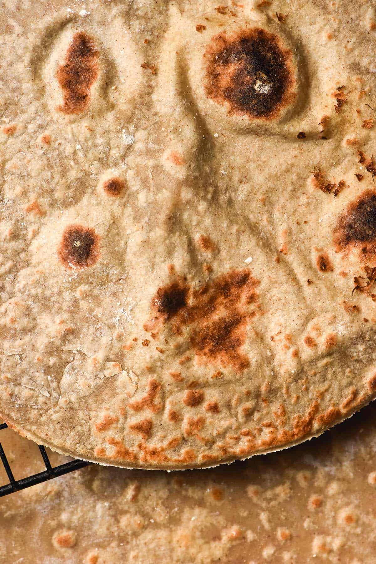 A macro close up of a gluten free buckwheat wrap on a cooling rack