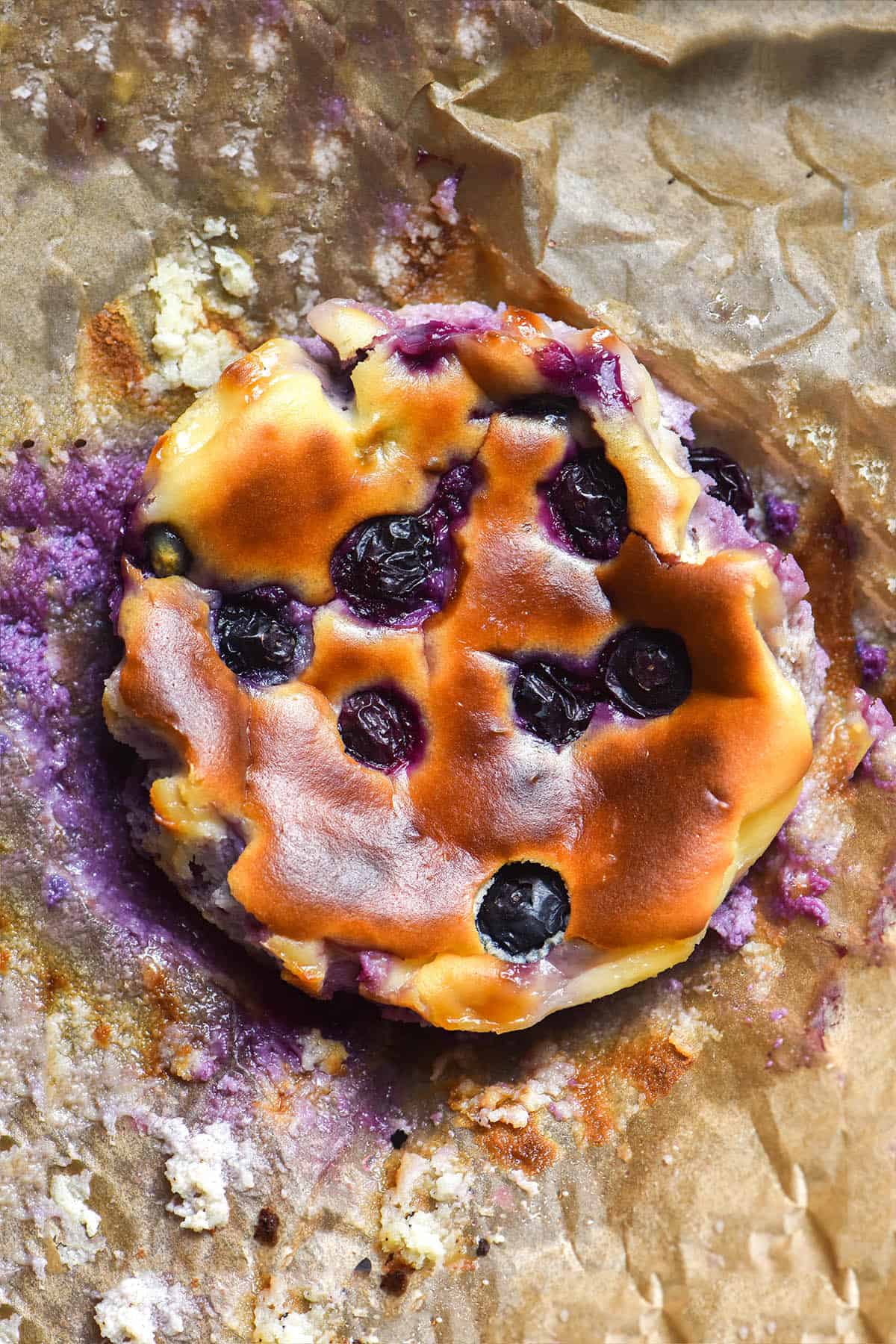 An aerial close up image of a blueberry mini cheesecake