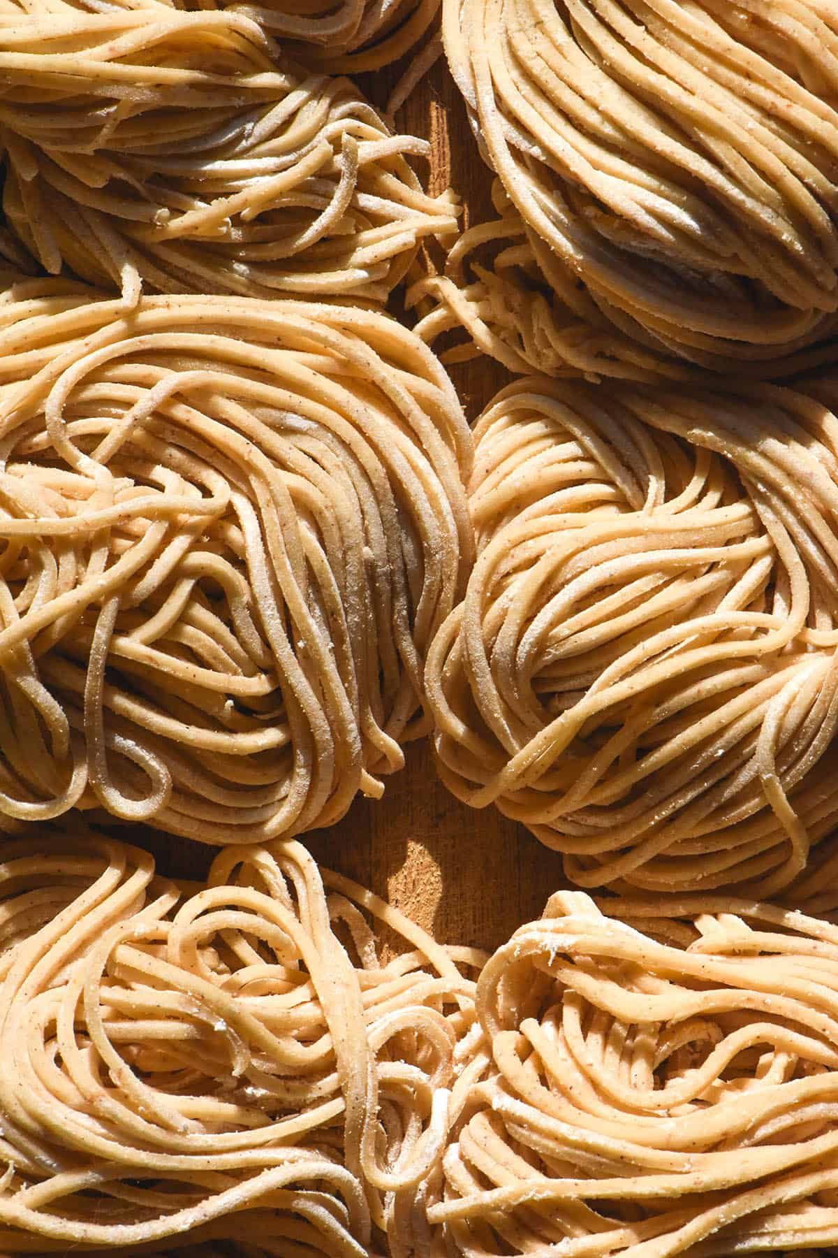 An aerial close up of gluten free egg noodles arranged in nests