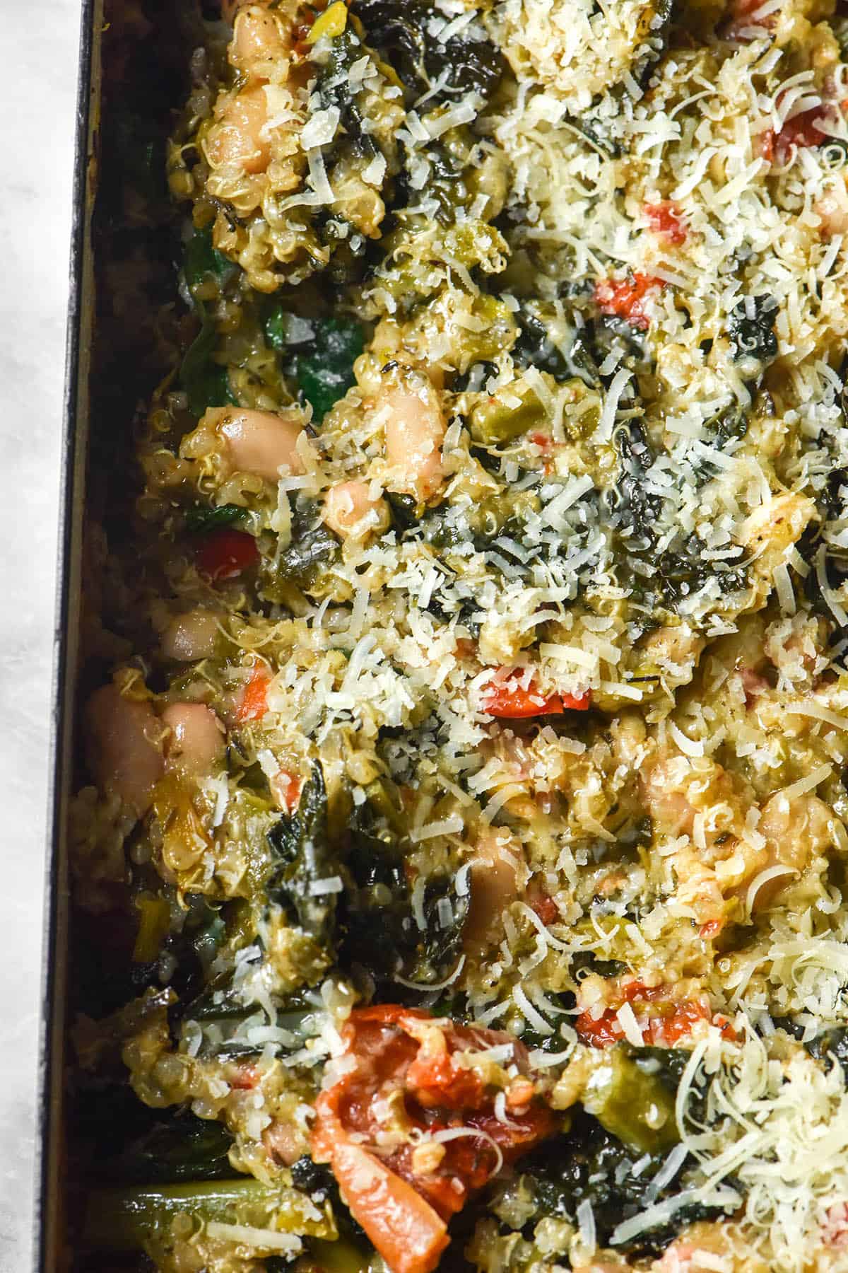 An aerial image of a white rectangular baking dish filled with Italian quinoa bake