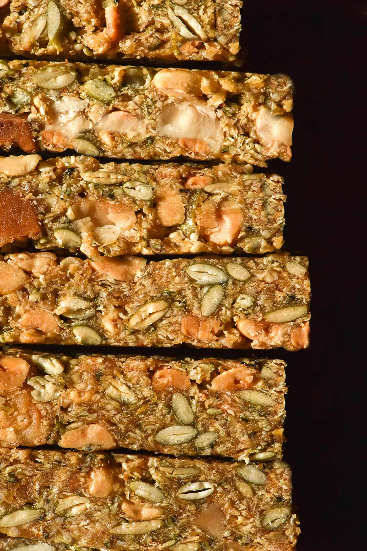 A highly contrasted image of Low FODMAP granola bars stacked on top of each other 