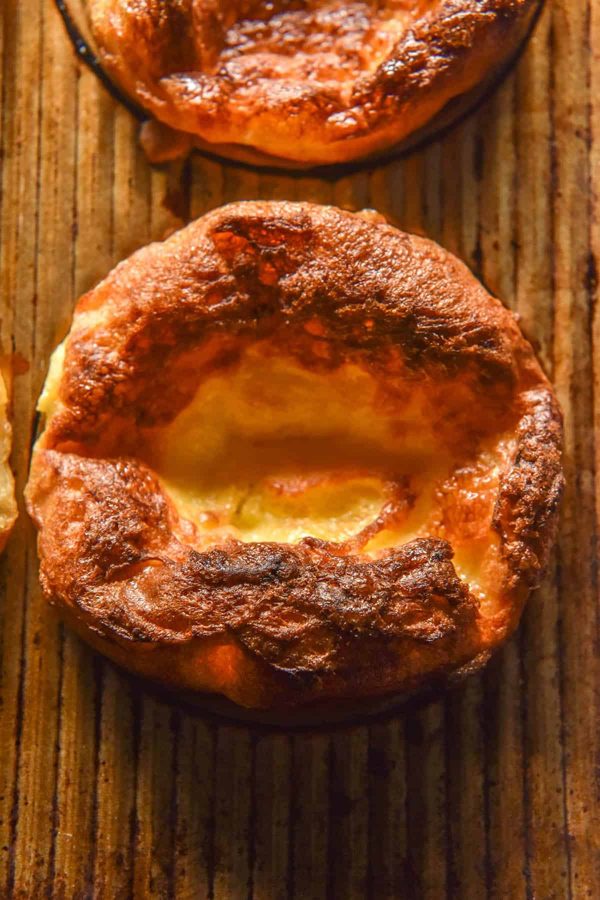 An aerial image of gluten free Yorkshire puddings in a steel baking tin