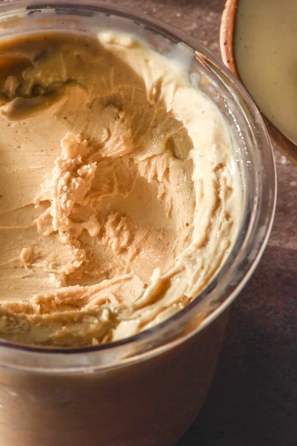 A side on warm toned image of a tub of high protein Ninja Creami ice cream