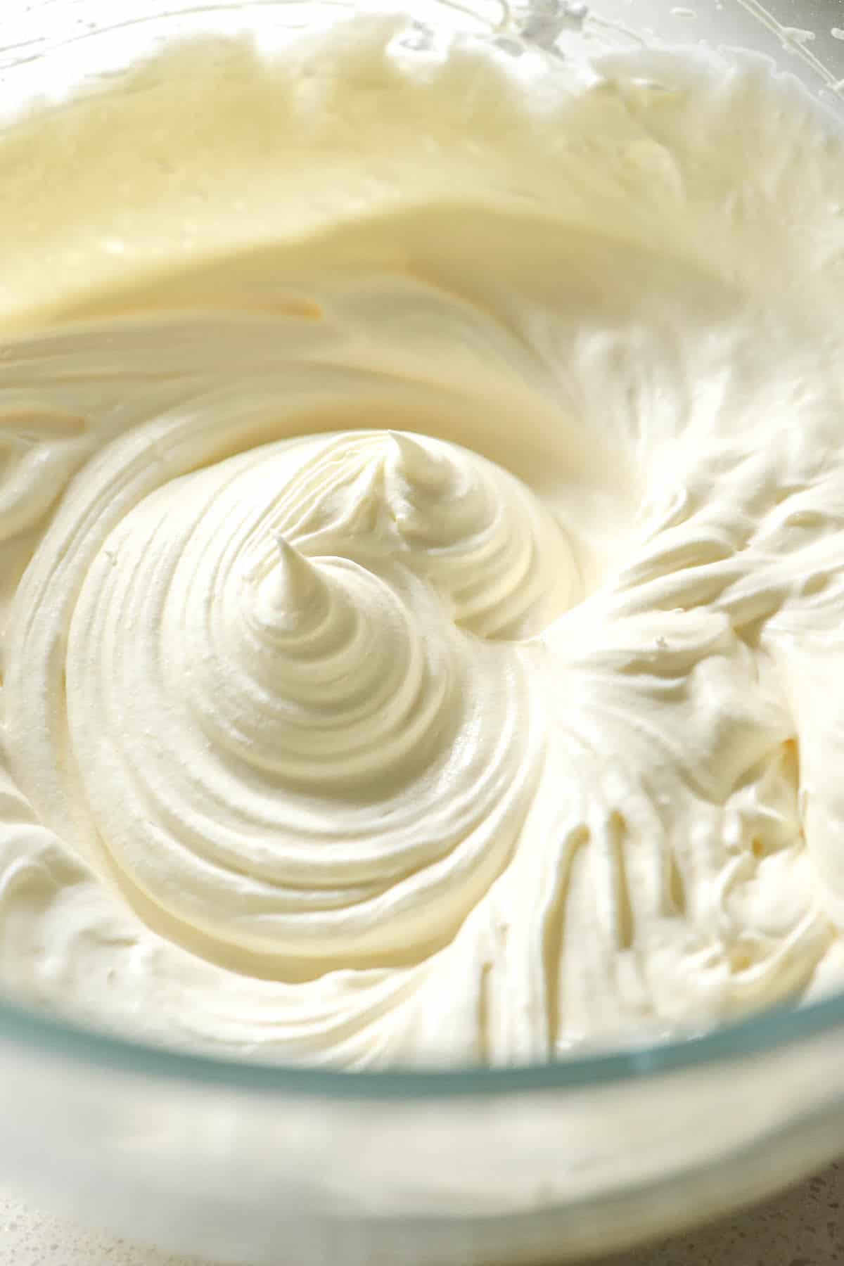 An aerial image of lactose free whipped cream in a glass bowl