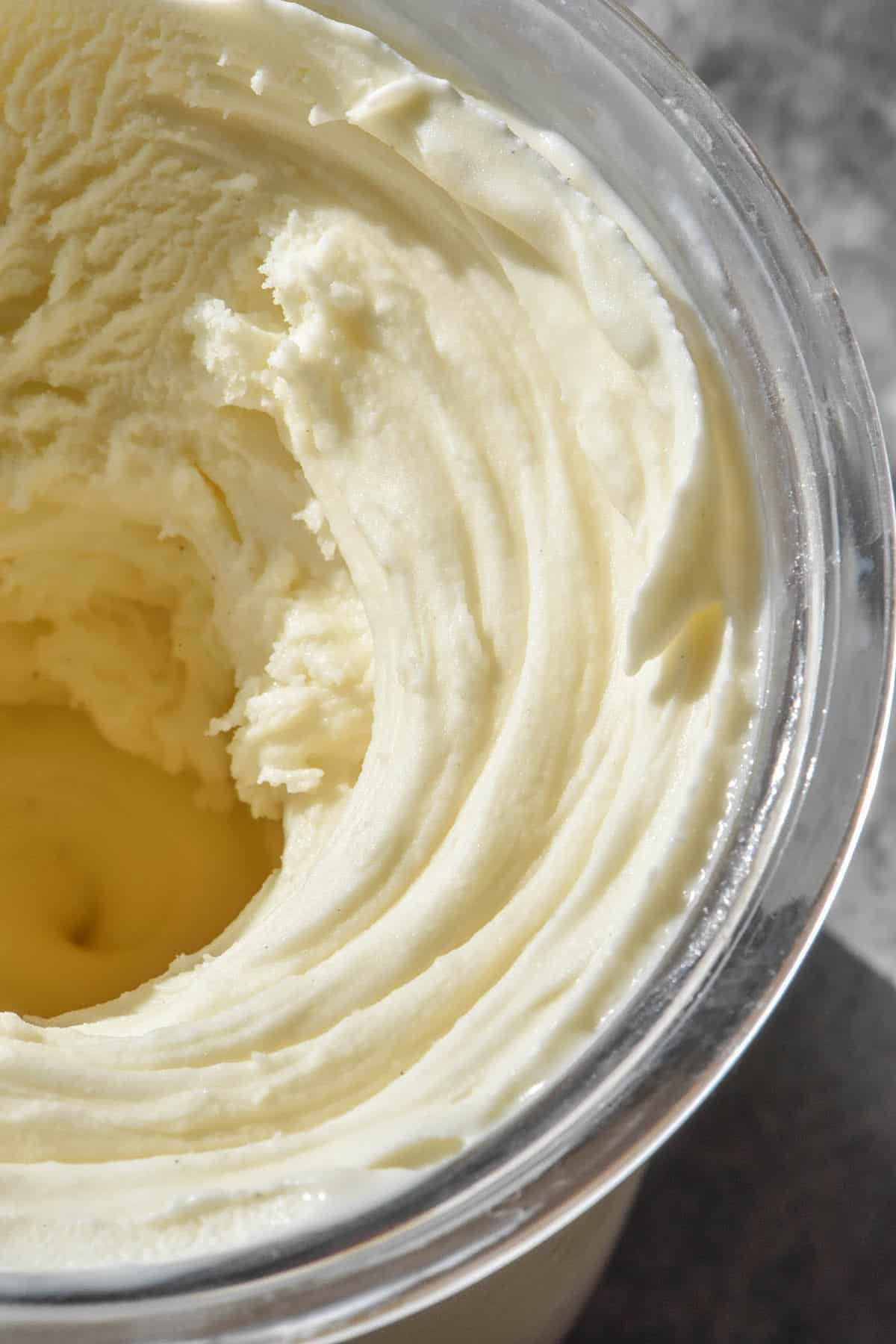 A sunlit close up image of Ninja Creami vanilla ice cream after it has been freshly spun in the machine