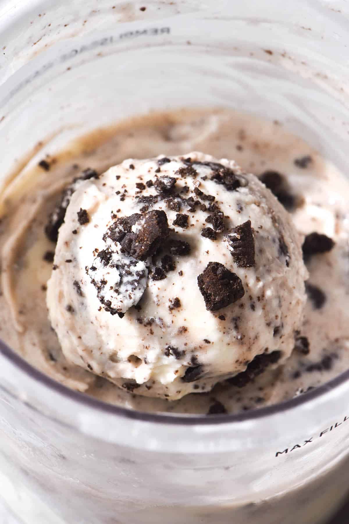 A macro close up of a scoop of Ninja Creami cookies and cream ice cream in the tub