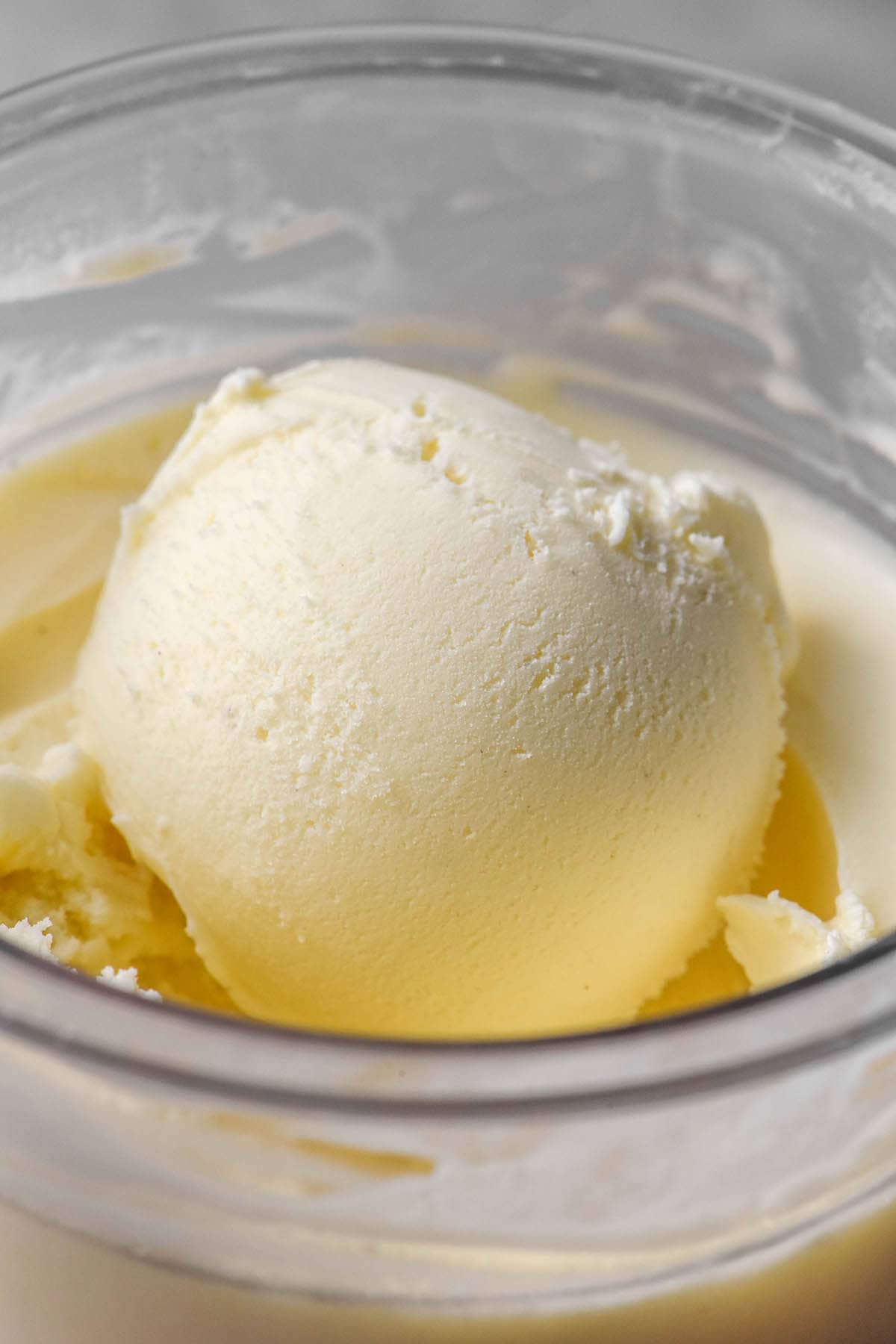 A side on macro image of a scoop of vegan vanilla ice cream in a Ninja Creami tub