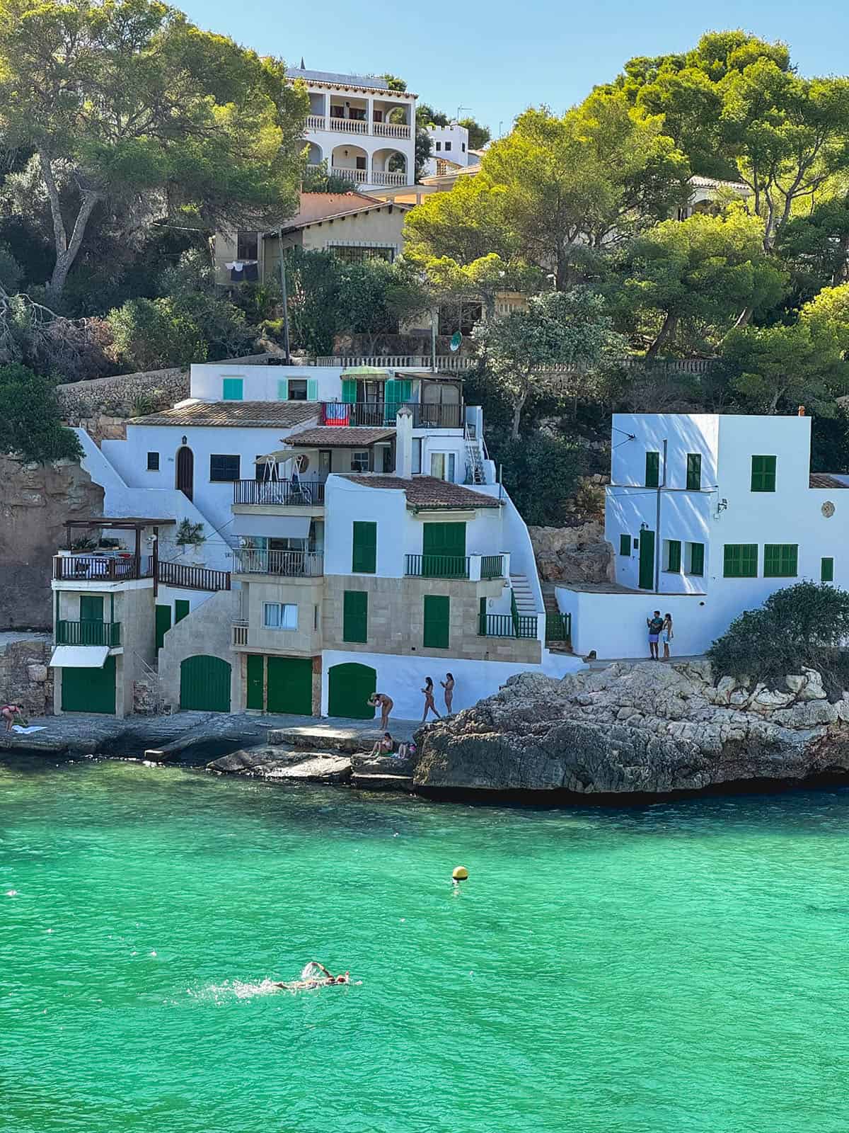 An image of the water and fishermen's houses in Cala Santanyi, Mallorca