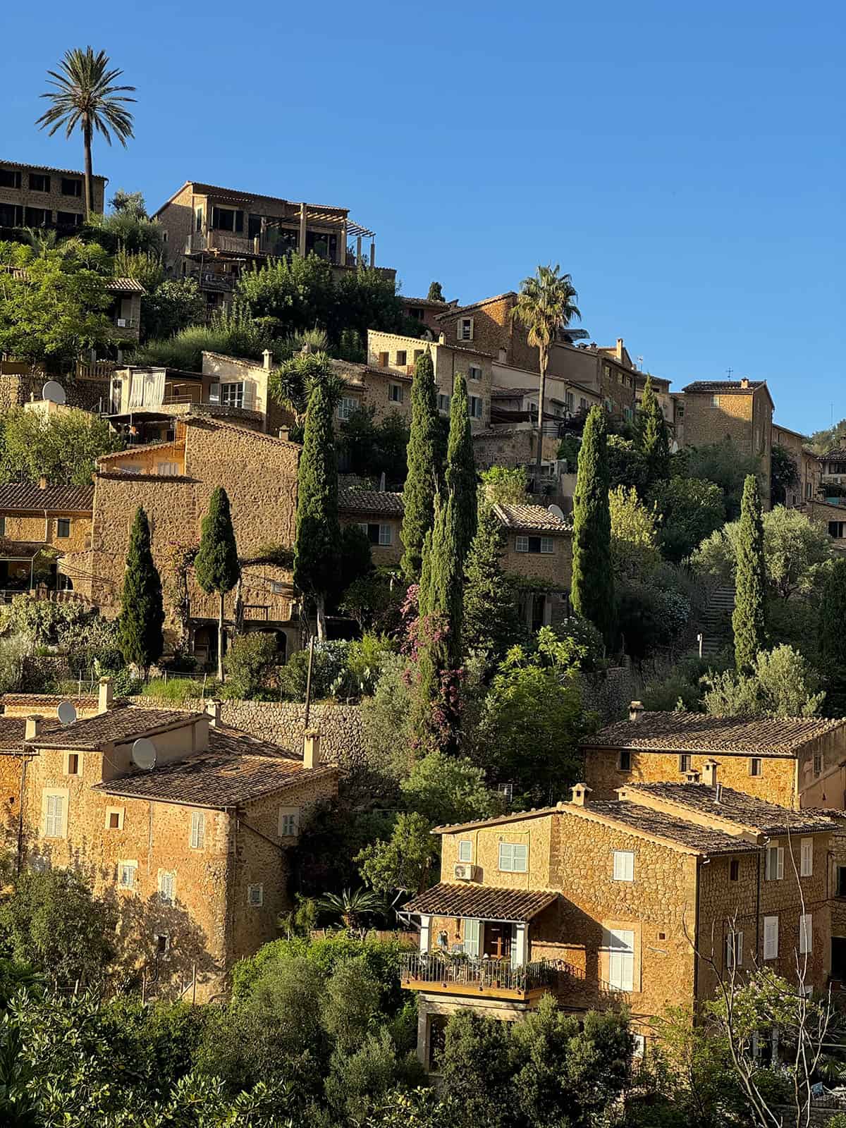 An image of the hillside houses in Deia in the afternoon sun