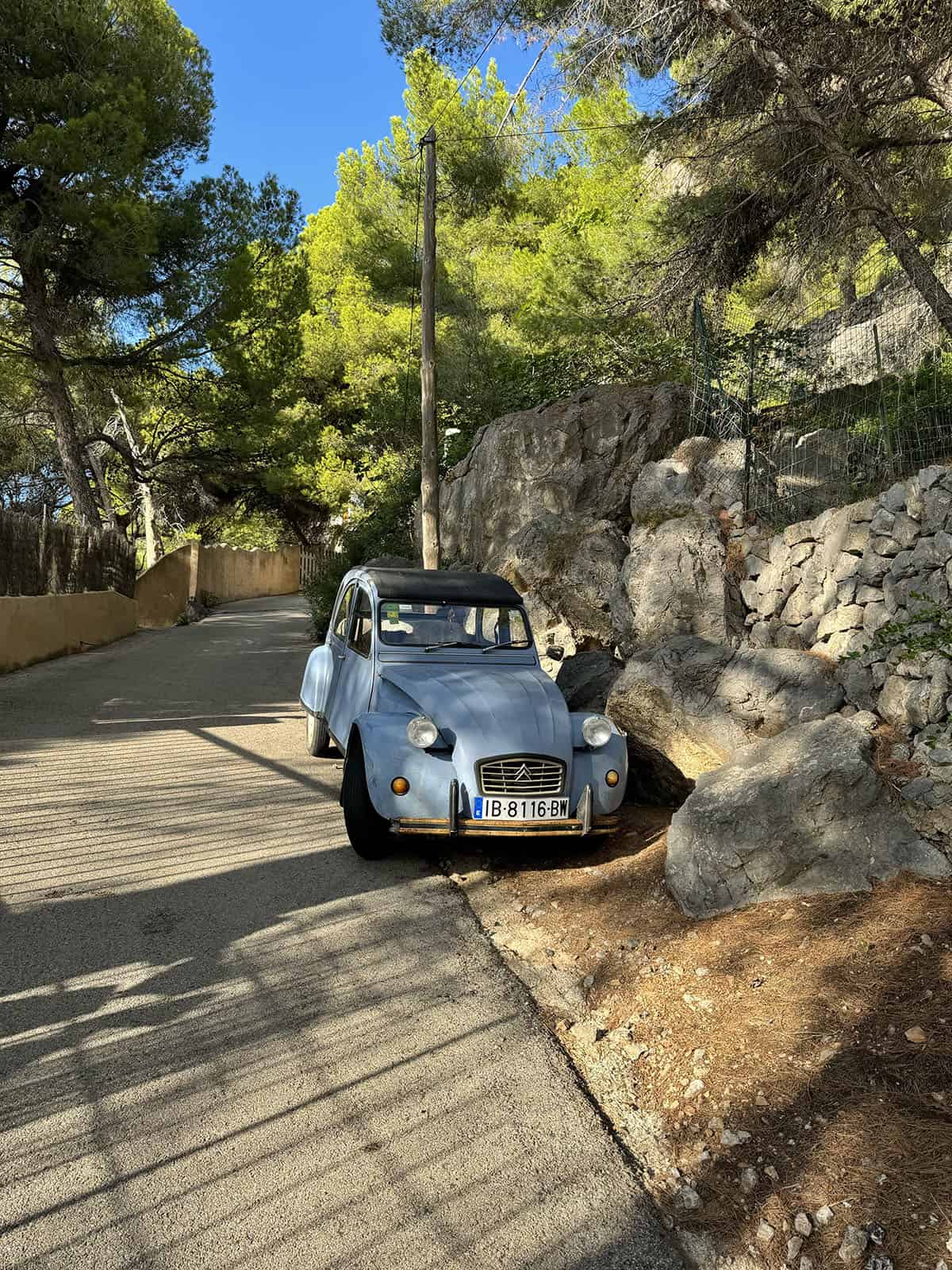 An image of an old blue car on the streets of Deia, Mallorca