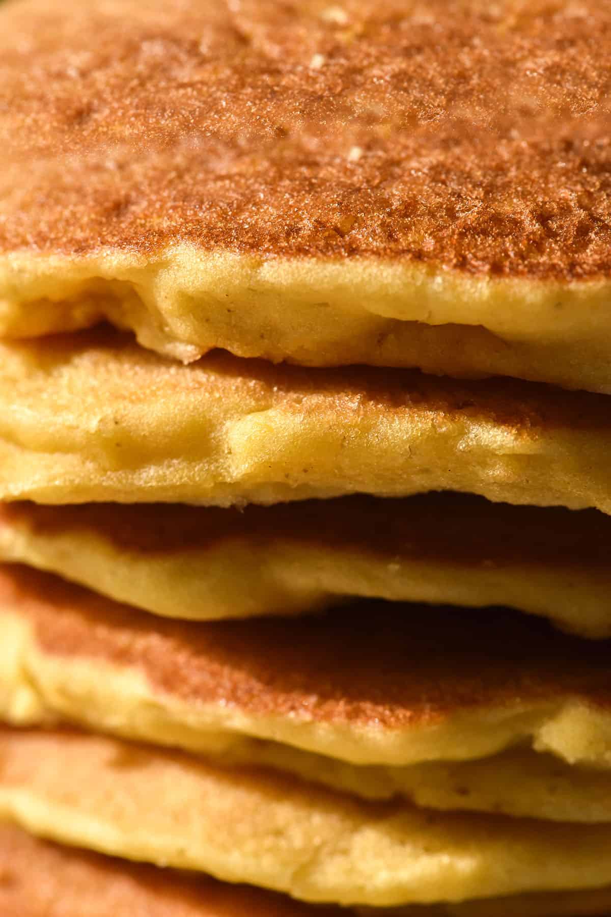 A macro close up image of a stack of gluten free cornmeal pancakes