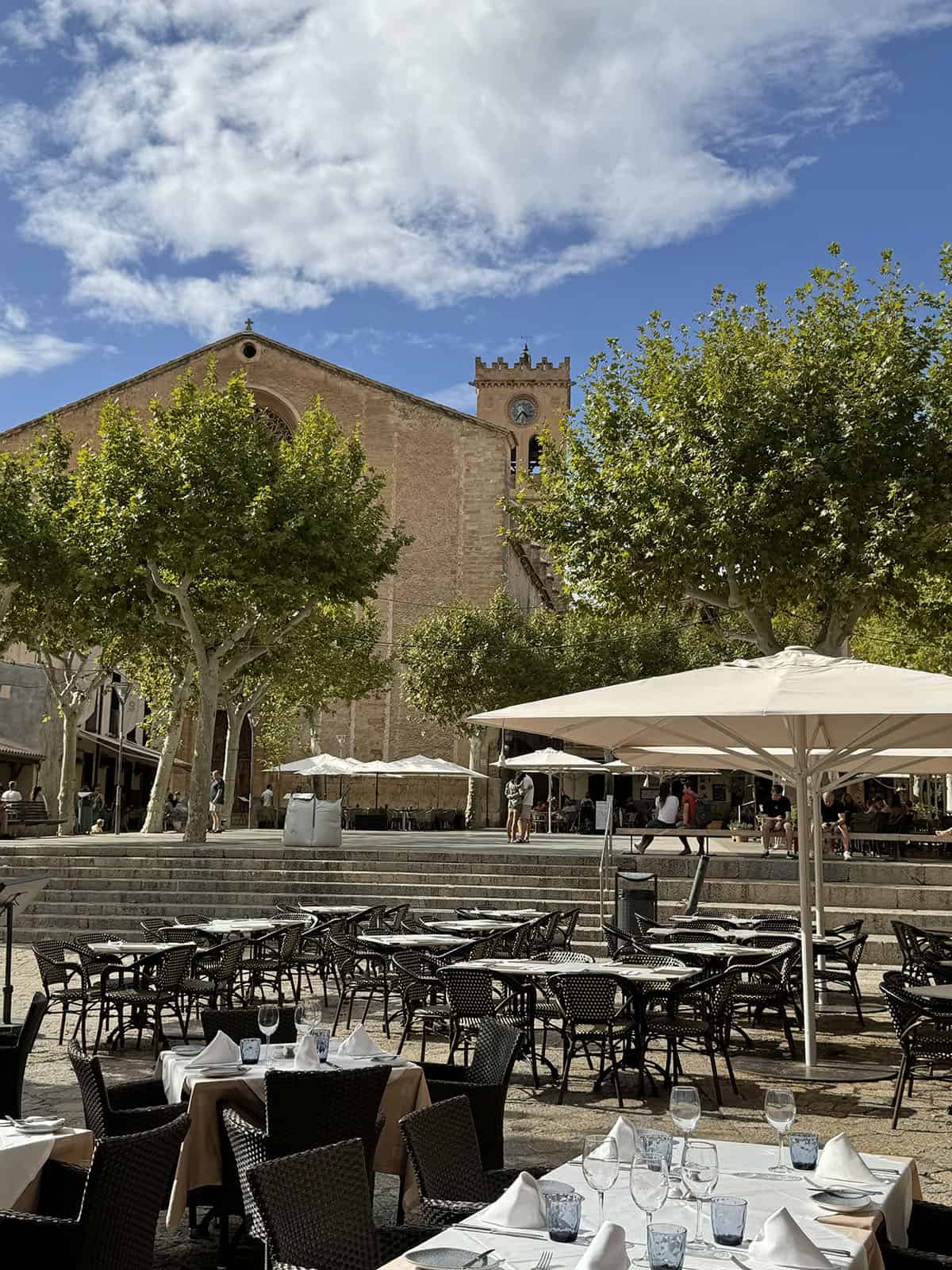 An image of Placa Major in Pollenca during a sunny morning